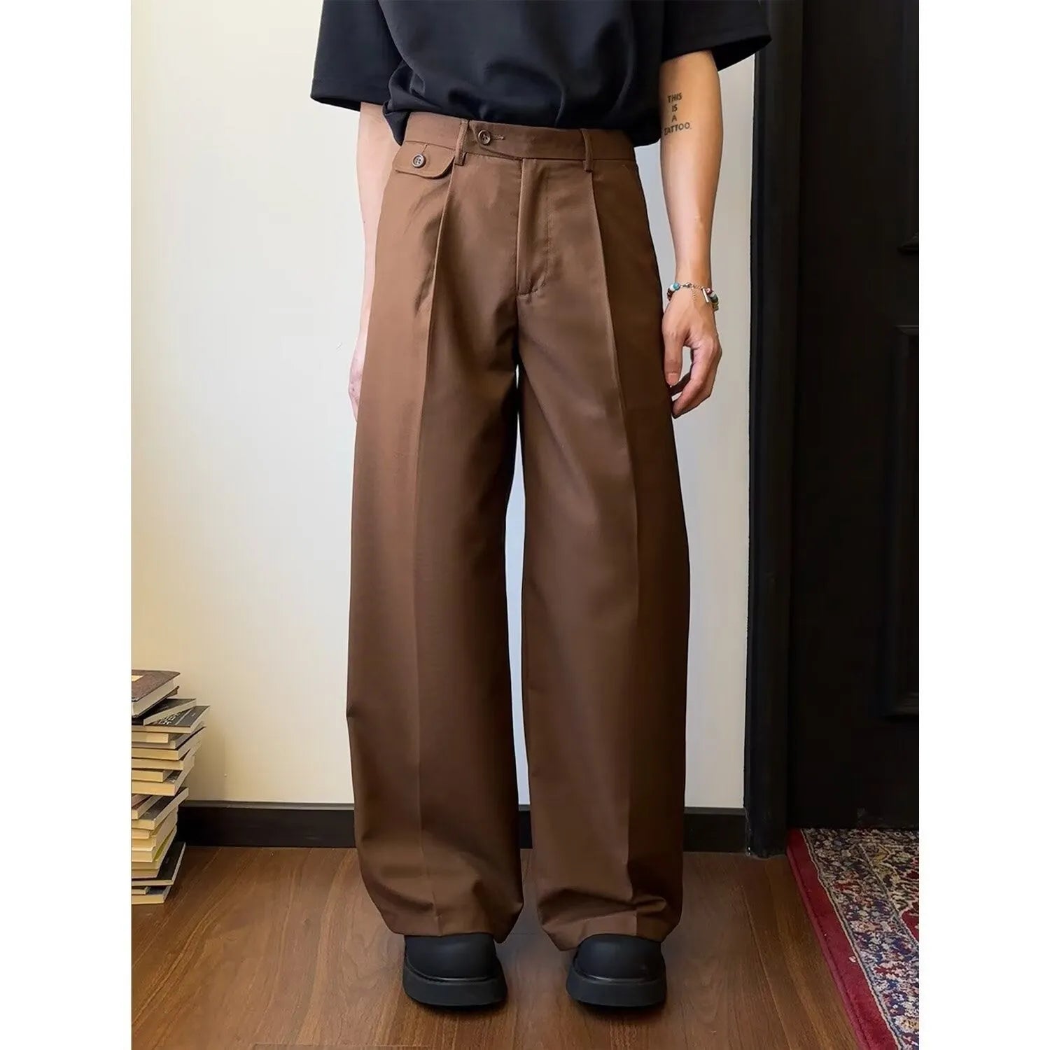 Man wearing brown straight-leg loose drape casual trousers with a relaxed fit.