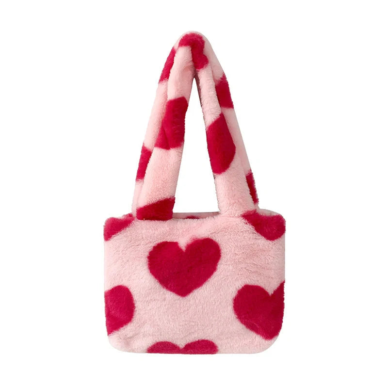 Soft, plush heart-shaped handbag in various vibrant colors with a magnetic closure and interior phone compartment