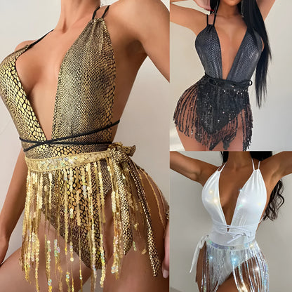 Gold backless one-piece swimsuit with tassel detailing on a solid colour background.