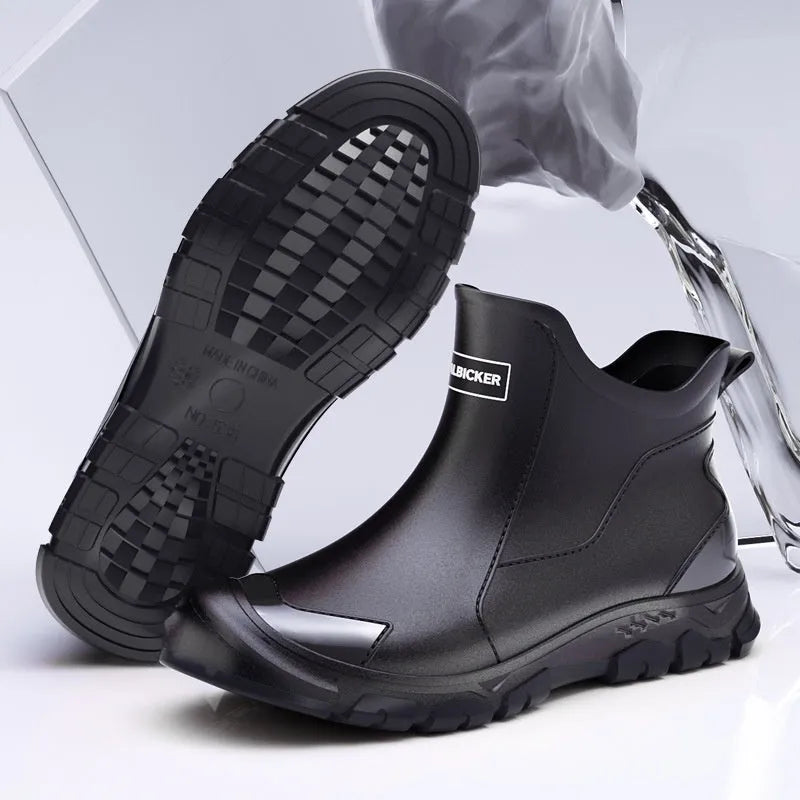 Low-cut solid colour PVC rain boot with round toe and plastic sole.