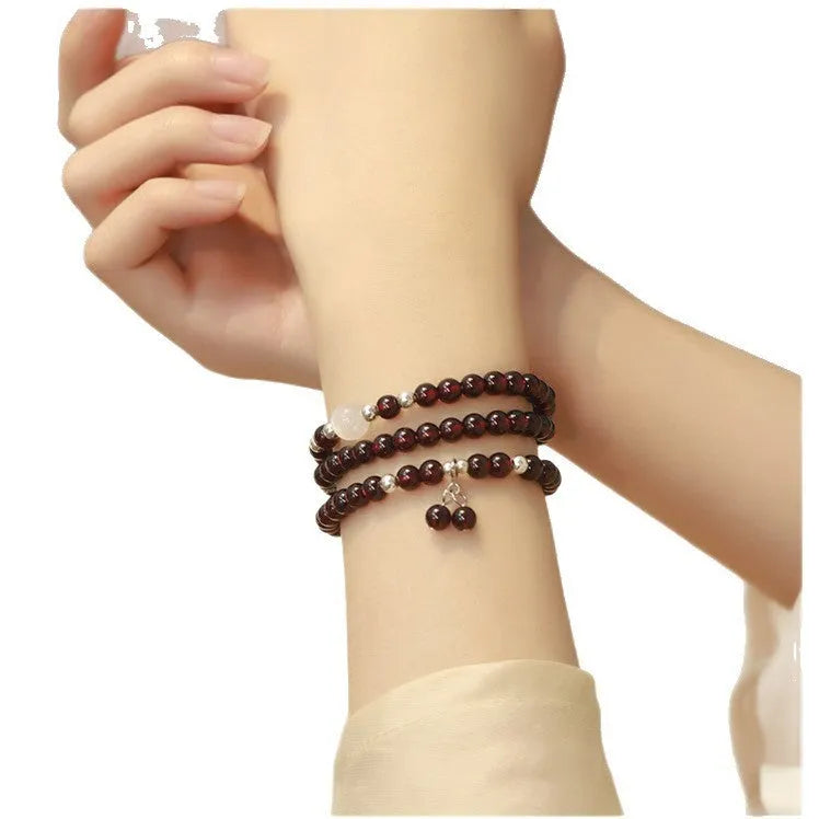 Handmade antique Chinese style bracelet with red imitation garnet and pomegranate design in a gift box.