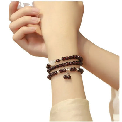 Handmade antique Chinese style bracelet with red imitation garnet and pomegranate design in a gift box.