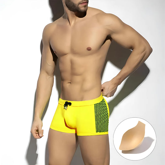 Men's yellow and black polka dot quick-dry swimming boxers on a plain background