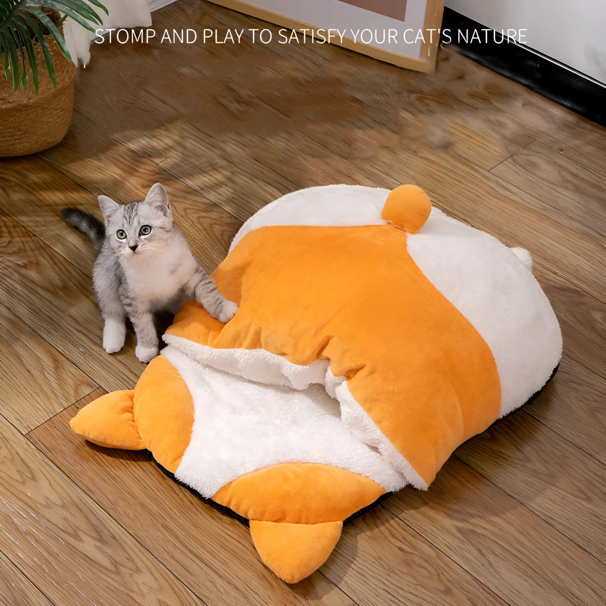 Orange semi-closed sleeping bag bed for cats on a floor, showing soft interior and dimensions.