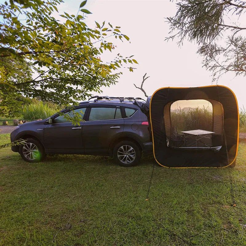Black pop-up quick-throw car tail tent unfolded to a 200cm cube, set up behind an SUV.