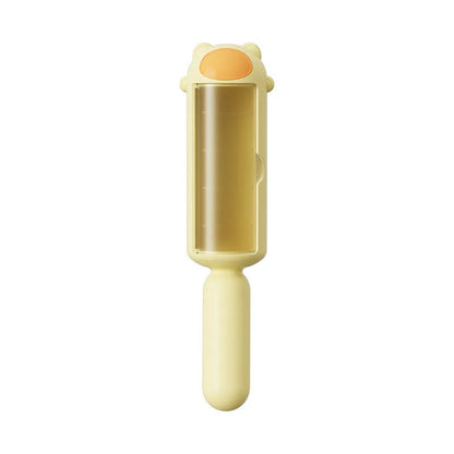 Blue pet hair remover with self-cleaning base rolling on a sofa to remove dog fur