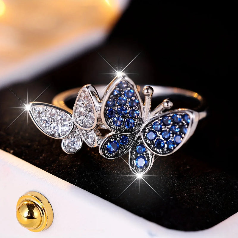 Butterfly ring for women in silver-tone blue and white electroplated copper, available in five standard ring sizes from UK size 6 to 10, a jewellery gift or everyday accessory featuring a winged insect design.