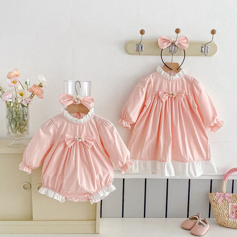 Triangle jumpsuit with princess-style dress detailing in peach branch climbing colour, available in sizes from 66cm to 140cm for girls, featuring long sleeves and pullover closure for easy wear