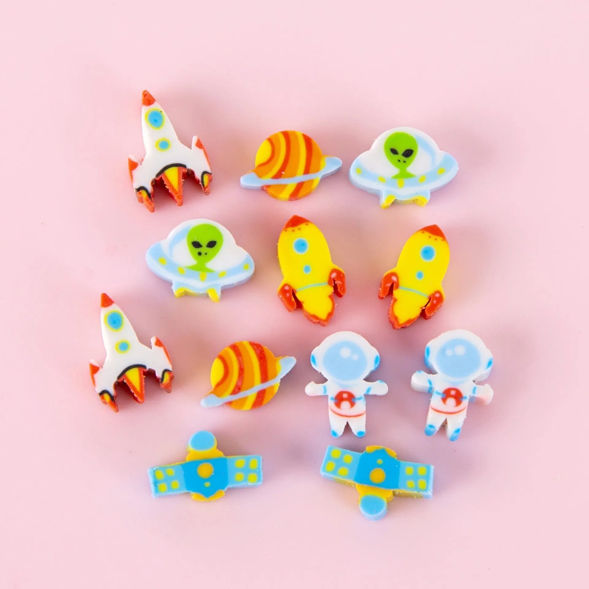Assortment of 50 small cartoon erasers in pearlescent bags, showing fruit, animal, and holiday designs.