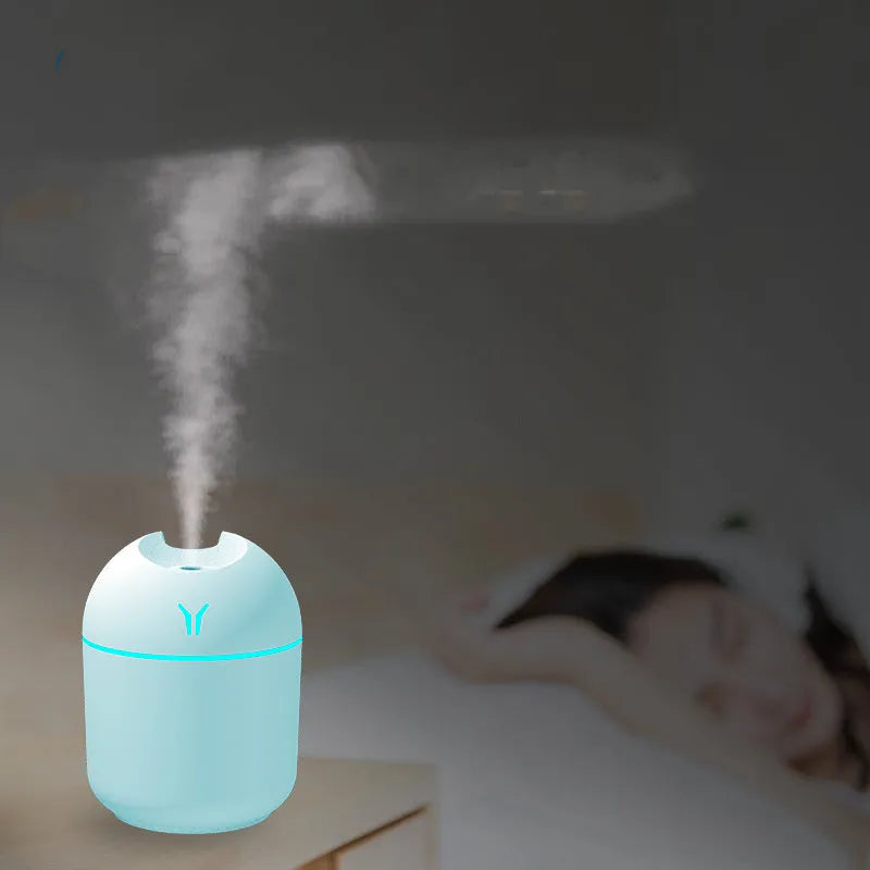 Mini round aromatherapy diffuser in ivory white with USB cable and essential oil bottle
