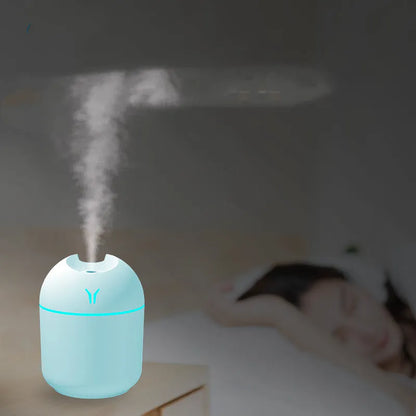 Mini round aromatherapy diffuser in ivory white with USB cable and essential oil bottle