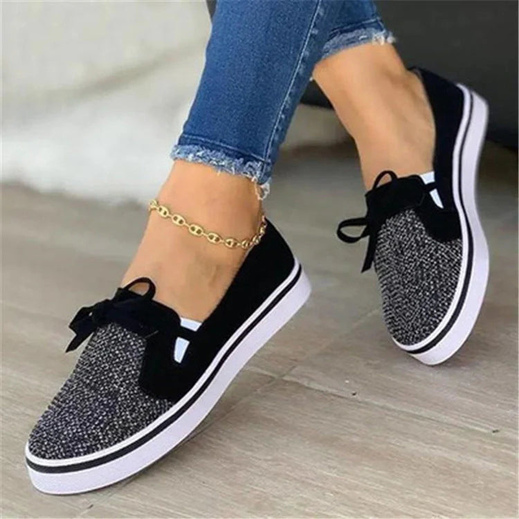Women's white lace-up canvas flat sneakers with cross straps