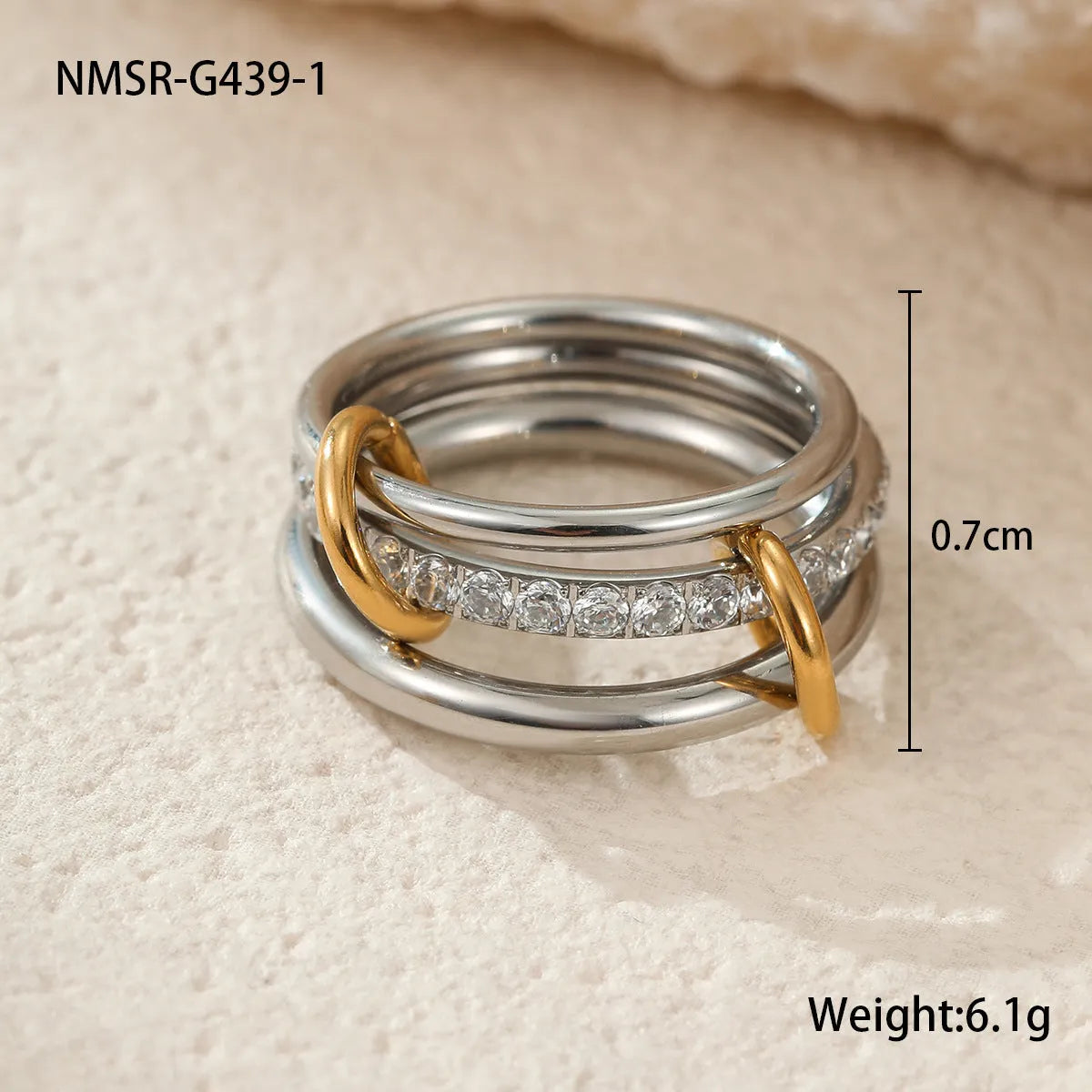 Stacked stainless steel rings with 18K gold plating in three colour variations, exaggerated hand jewellery designs