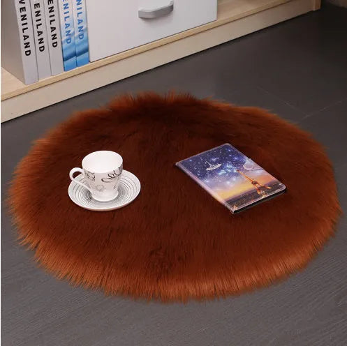 Round plush wool carpet in beige colour on a wooden floor.