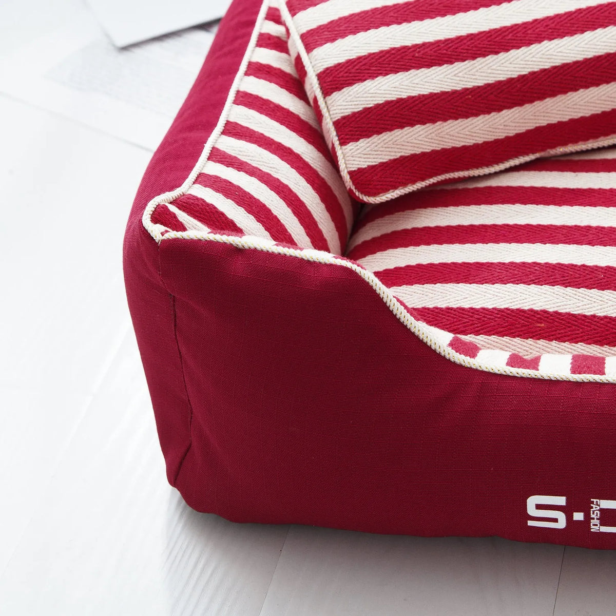 Navy striped removable dog kennel mat with a matching mini pillow, shown in blue and red colour options.