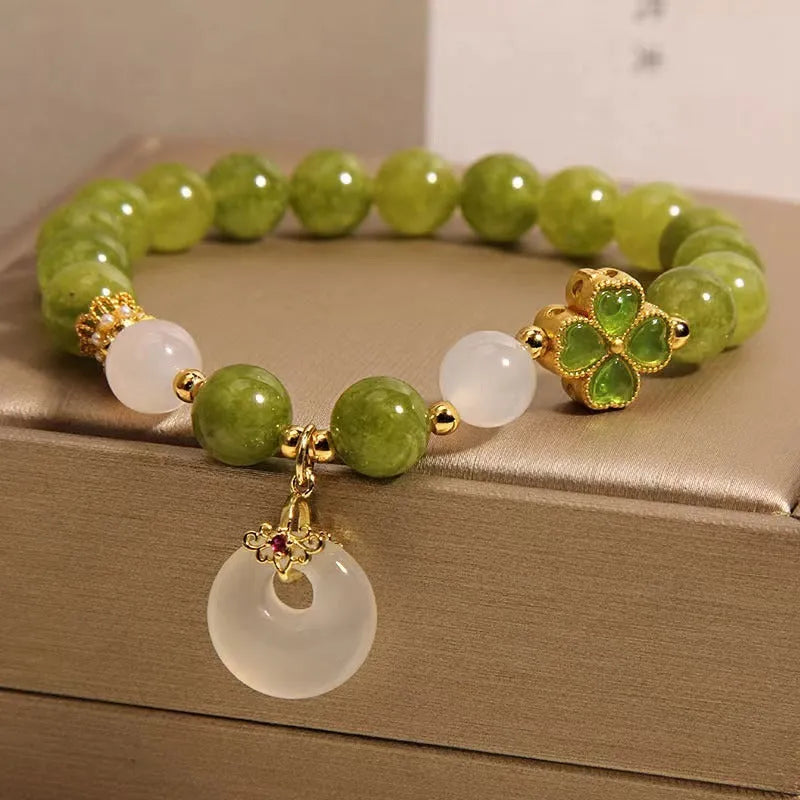 Women's natural stone bracelet crafted from green tourmaline with a four-leaf clover safety buckle for a secure fit, featuring a drop-shaped geometric design and a new Chinese style suitable for travel commemoration gifts.