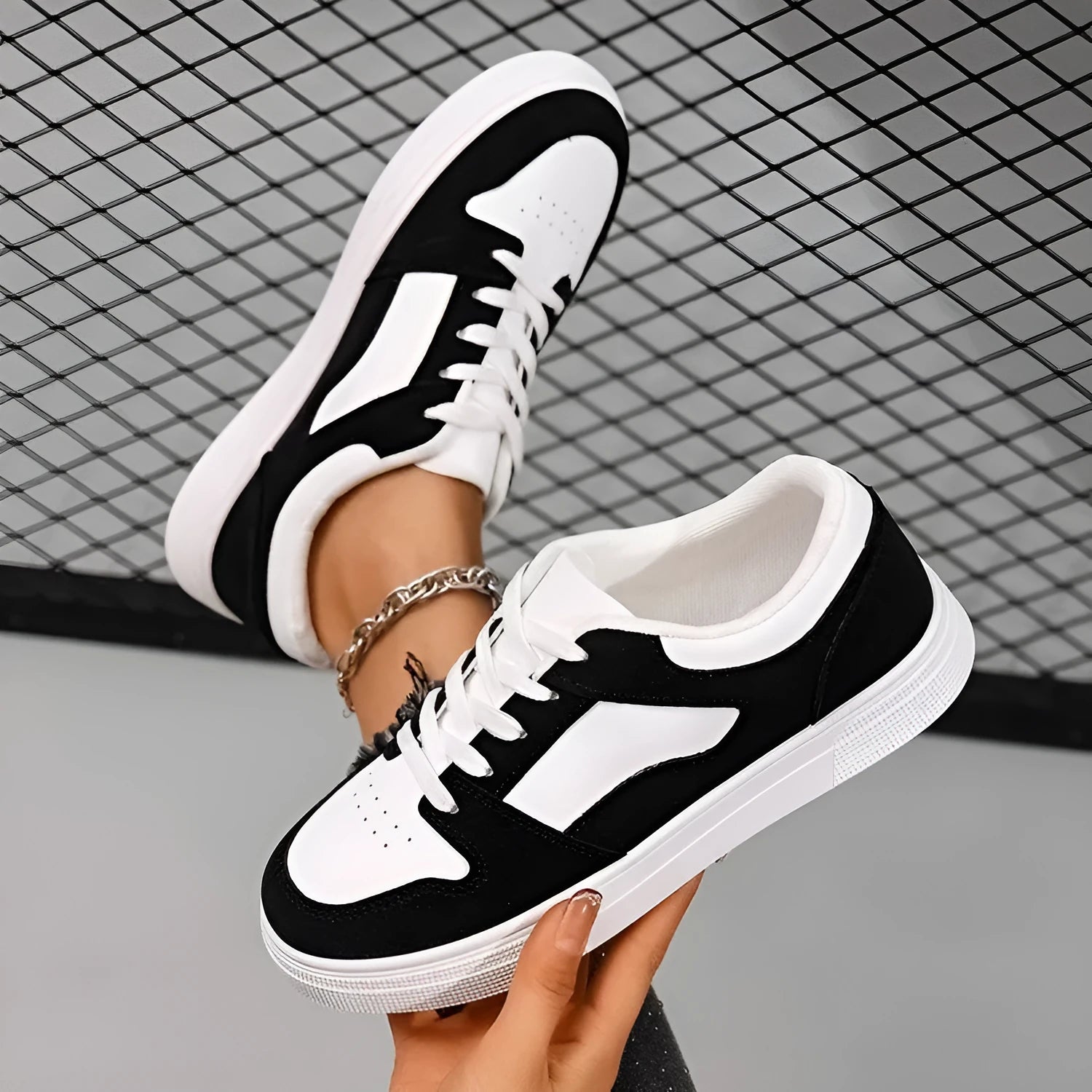 Black women's low-top lace-up casual sports shoes with a round toe and flat rubber sole.