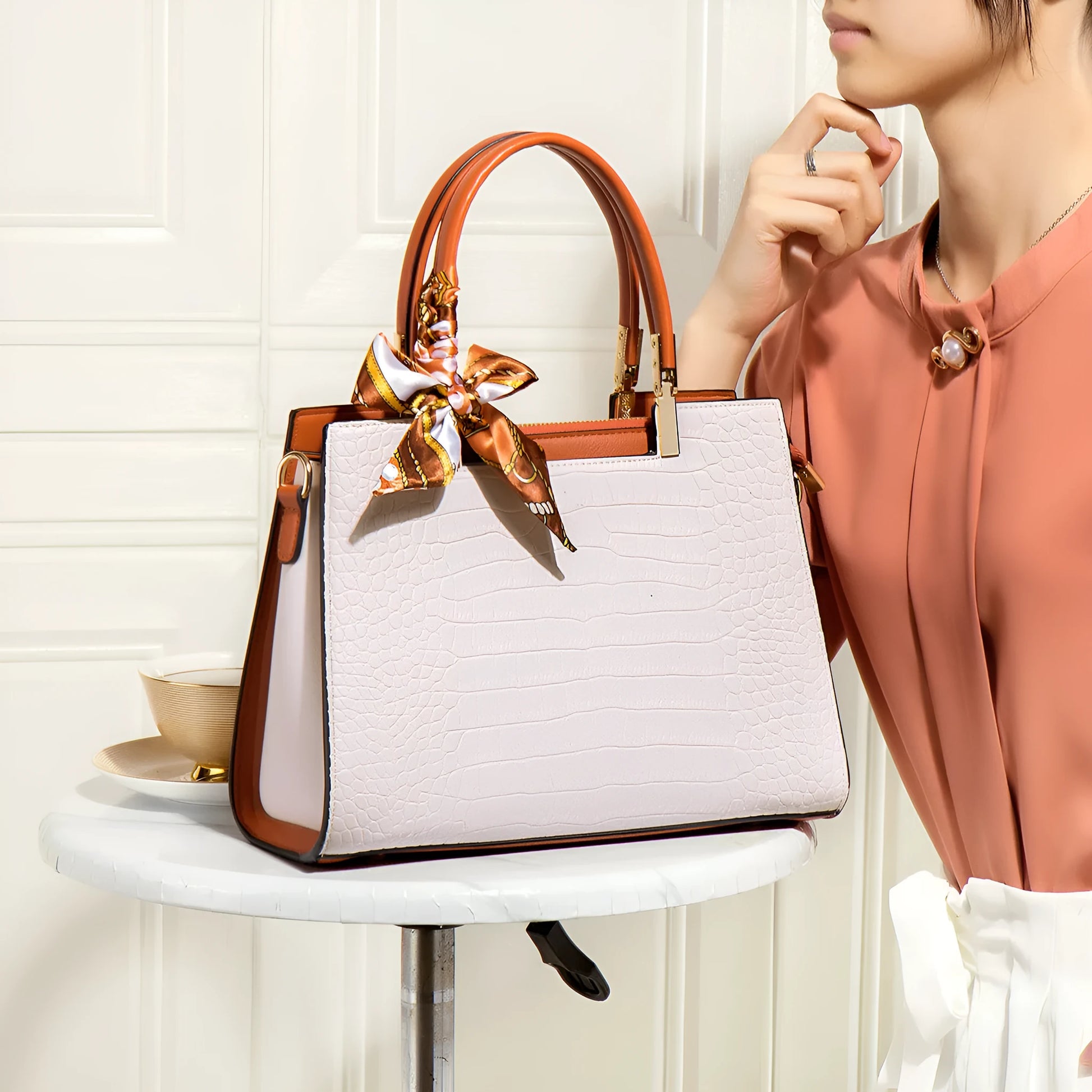 Milky white women's large shoulder handbag with interior organiser pockets and horizontal square shape.