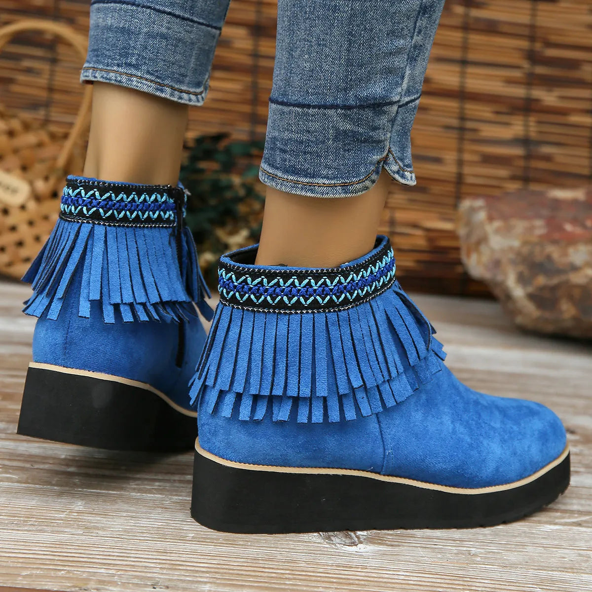 Women's thick bottom wedge bootie in suede with side zipper and tassel detail, available in multiple colours.