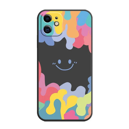 White silicone iPhone case with rainbow smiley face pattern and attached lanyard