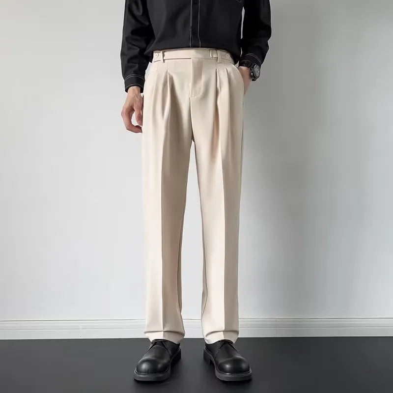 Men's apricot and black straight-leg loose fit suit trousers on a hanger.
