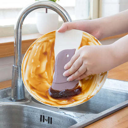 Penguin-shaped silicone kitchen scraper with soft blade for cleaning plates and pots