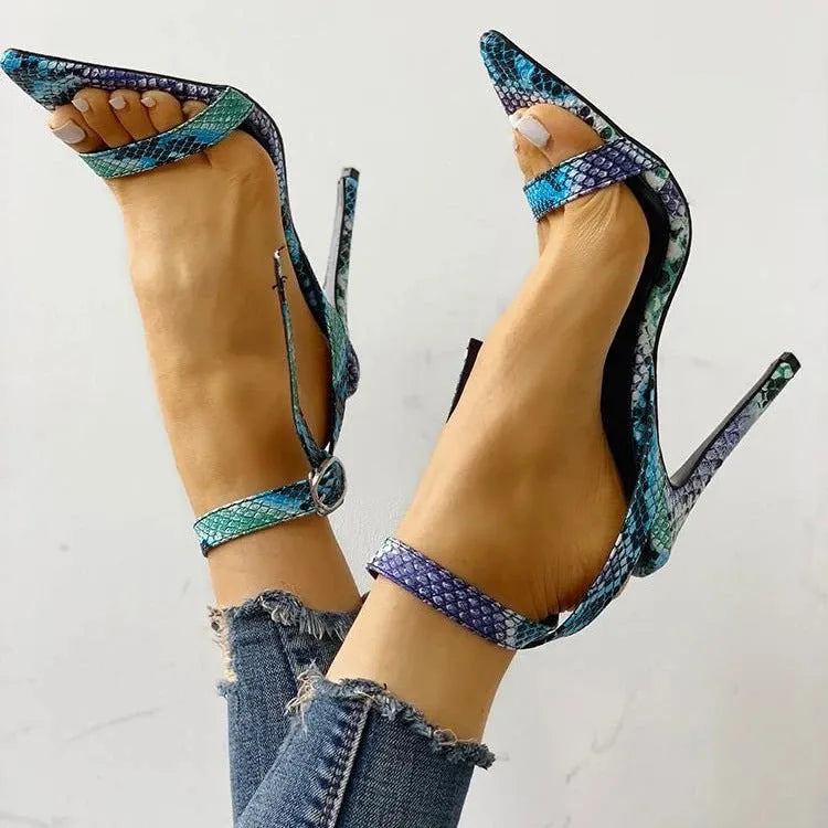 Blue women's high heels with a buckle strap and hollow-out pattern on the PU leather upper.