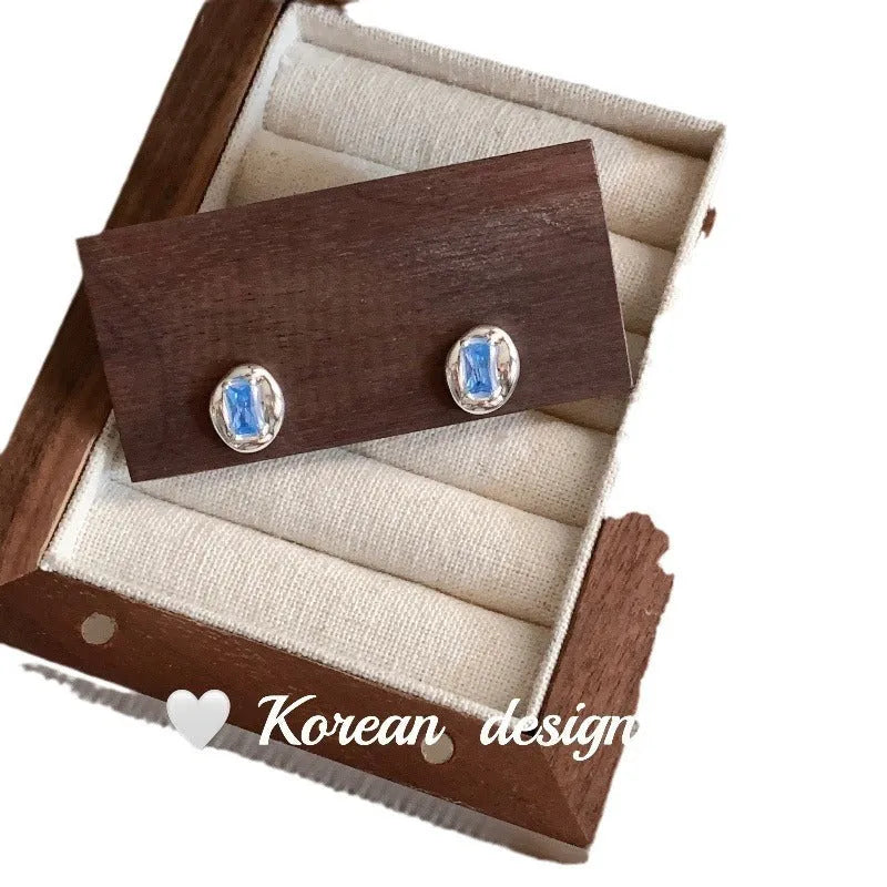 Women's S925 sterling silver earrings with oval blue diamond heart-wrapped design