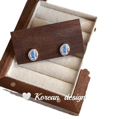 Women's S925 sterling silver earrings with oval blue diamond heart-wrapped design