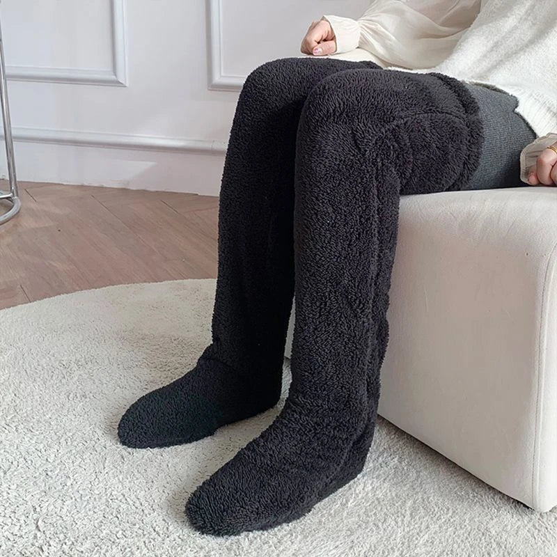 Cozy over-the-knee fuzzy socks in various colors, including brown, blue, dark gray, pink, silver, and more. Comfortable cotton design for warm, snug legs.