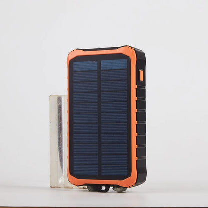 Orange and green hand solar power bank with solar panel, USB ports, and LED light showing 12000mAh capacity