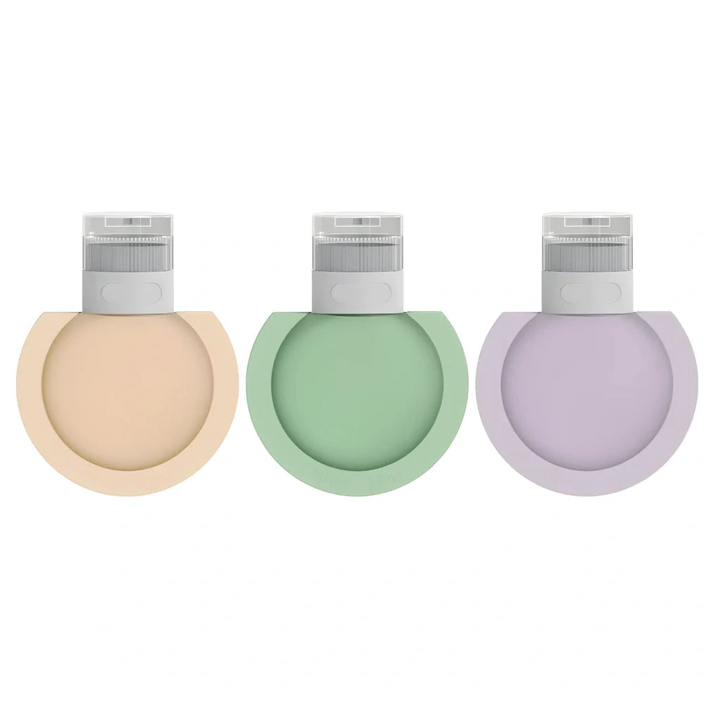 Three silicone travel bottles in different colours with stickers, showing 60ml and 90ml sizes for shampoo and cosmetics