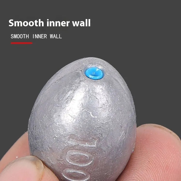 Rugby-shaped lead fishing sinker with scaled texture and plastic core protection for sea fishing