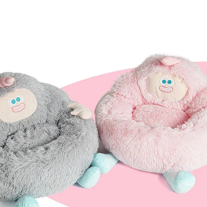 Grey plush donut-shaped pet nest bed with raised edges for a cat or dog.