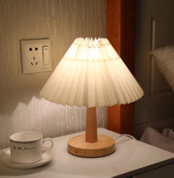 Vintage-inspired desk lamp with a pleated fabric shade, bamboo base, and touch-sensitive dimming controls