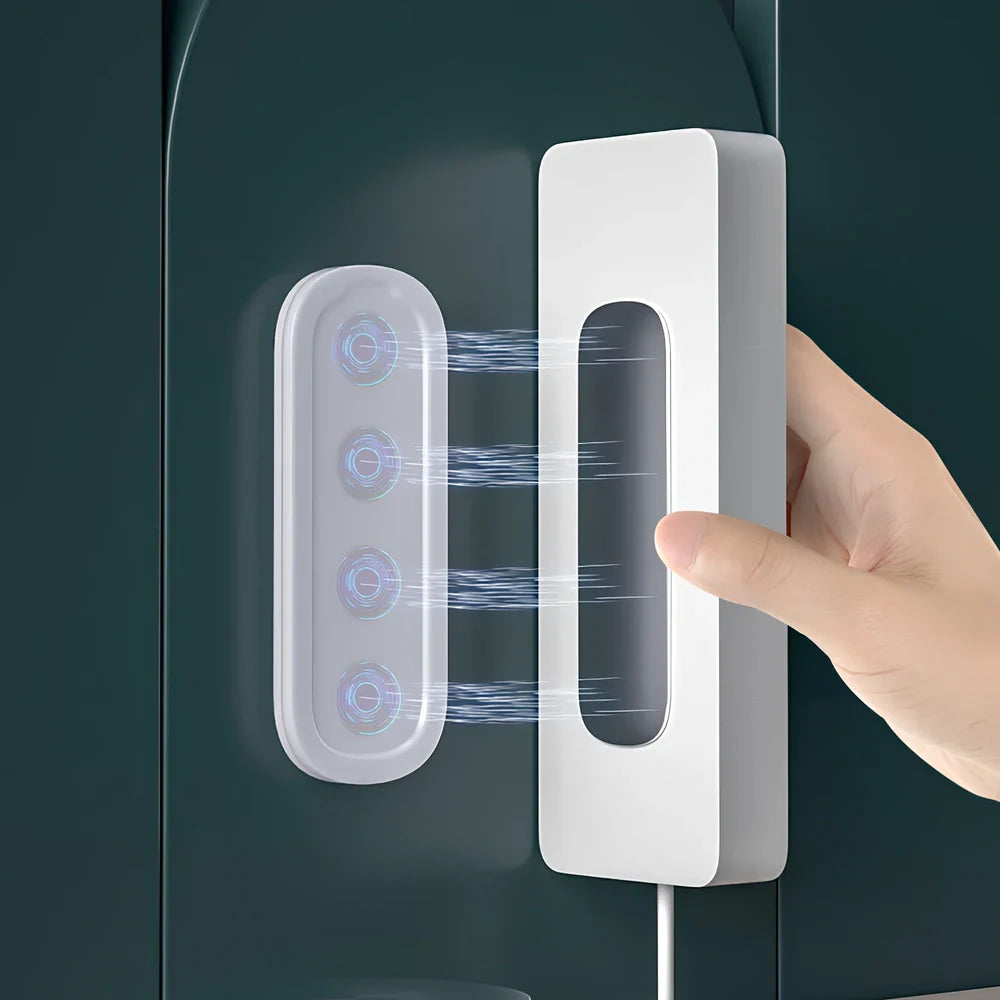 White magnetic socket organiser mounted on wall holding power board with cables organised