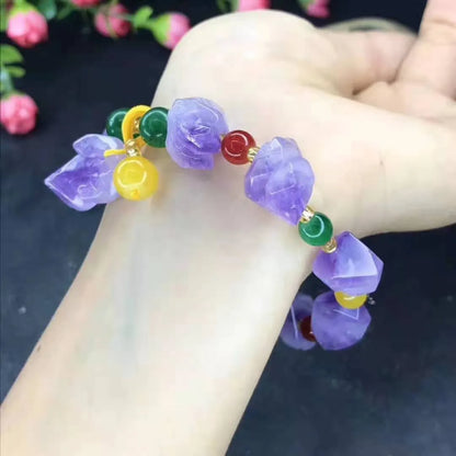 Natural shaped purple amethyst bracelet for women with a fu character bead on a white background.