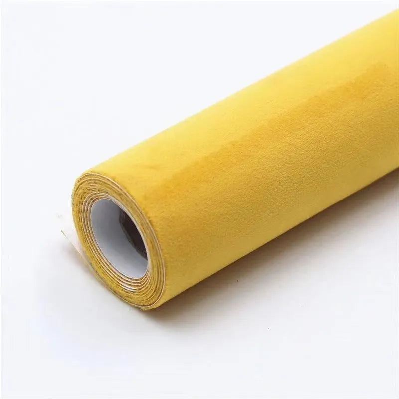 Rolls of self-adhesive leather suede in multiple colours showing texture and adhesive backing.