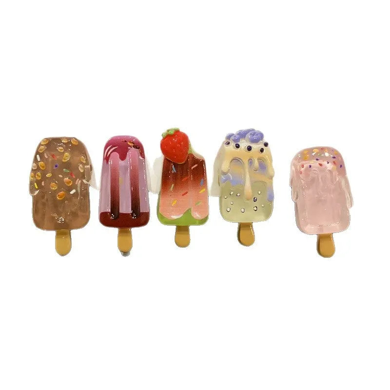 A resin hair barrette with a cartoon ice cream charm on a side-clip, shown in a pink colour variant.