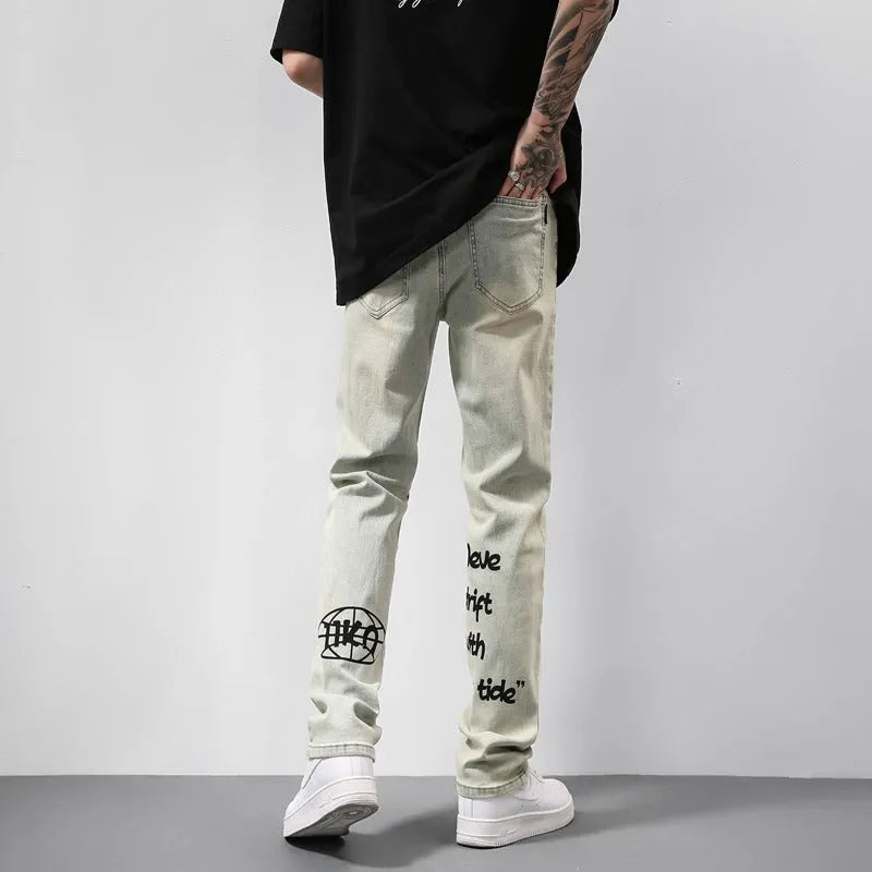 Khaki vintage washed straight-leg jeans with yellow mud dye and letter print, non-stretch mid-rise denim trousers.