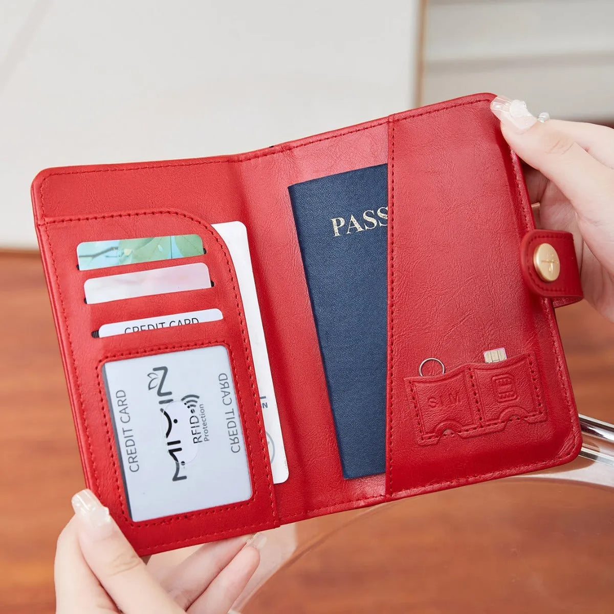 Simple PU leather passport holder in sapphire blue with visible sewing lines, showing card slots and RFID protection.