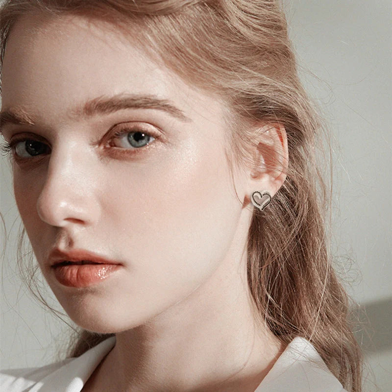 Stylish copper heart-shaped earrings with a double buckle closure, a trendy and elegant fashion accessory
