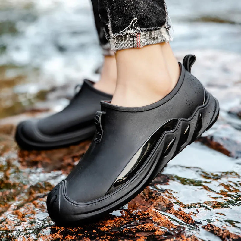 Men's short black plastic rain boots showing casual design and waterproof construction