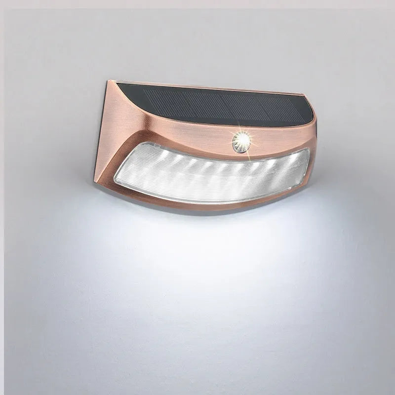 Solar outdoor wall lamp with smiling face design measuring 153mm × 76mm × 38mm for garden lighting