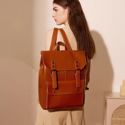 Genuine cowhide leather backpack for women in black, brown, or coffee, showing hard-textured two-layer construction.