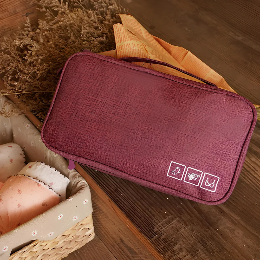 Purple cube-shaped bra storage bag with 3 internal shelves for organising underwear during travel