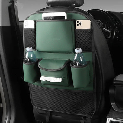 Black leather car seat back storage bag with multiple pockets, hanging behind a car headrest.