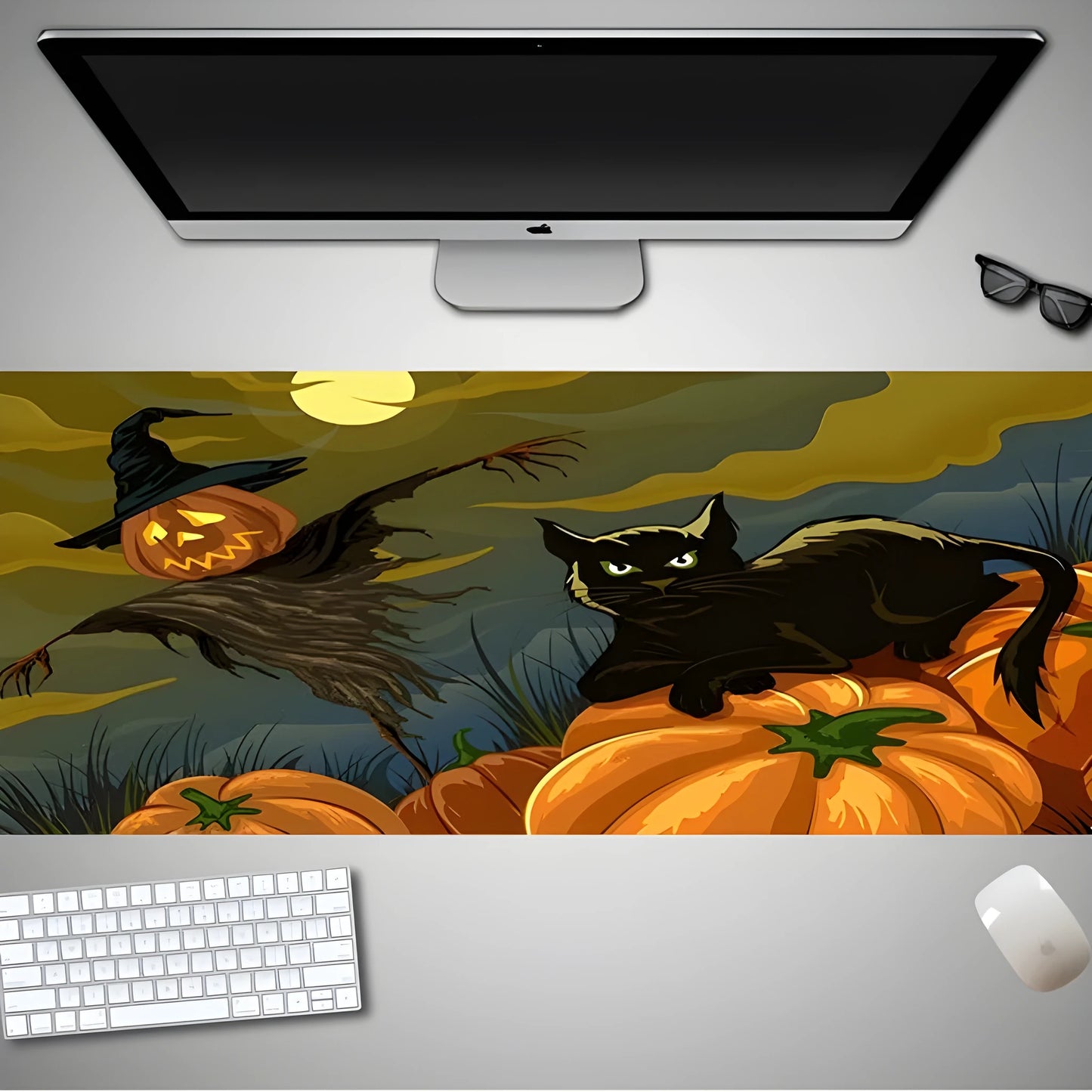 Oversized black Halloween-themed mouse pad with graphic design on a wooden desk, showing non-slip rubber base.