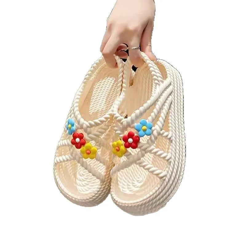 Women's beige PVC sandals with a sunflower pattern and round toe on a non-slip sole.