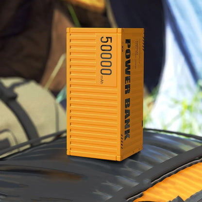 Yellow 50000mAh portable power bank with digital display showing battery percentage and multiple USB ports.
